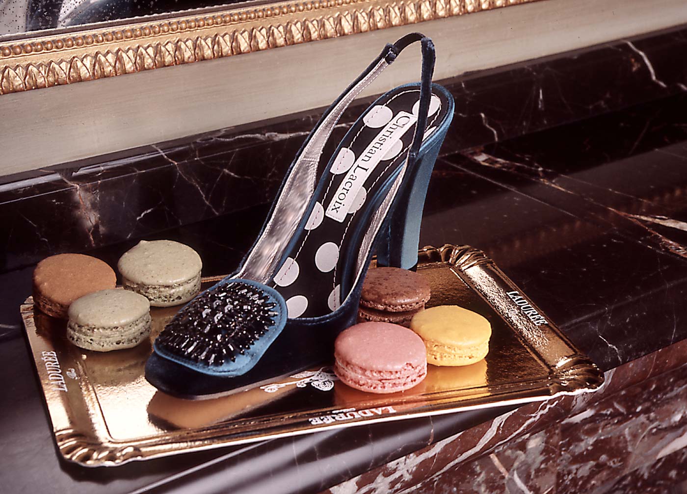 ladies shoe and macarons on serving tray