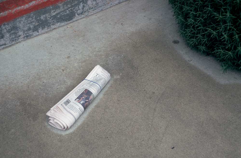 newspaper delivery in front of door step